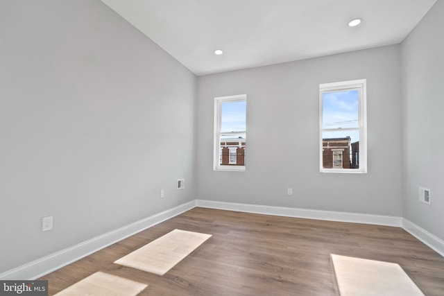 unfurnished room with hardwood / wood-style floors