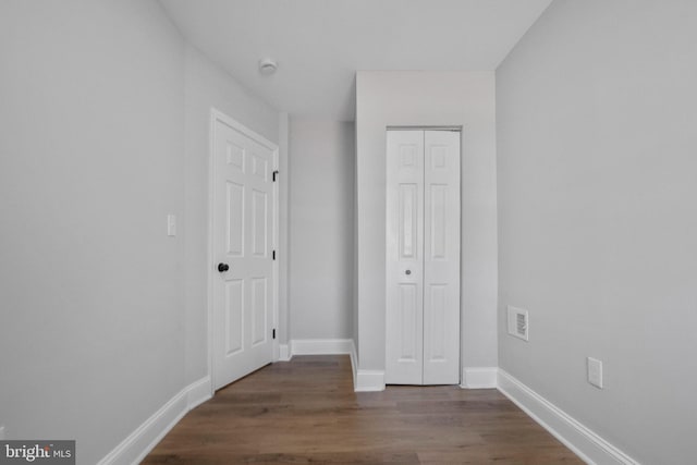 interior space featuring dark hardwood / wood-style floors and a closet