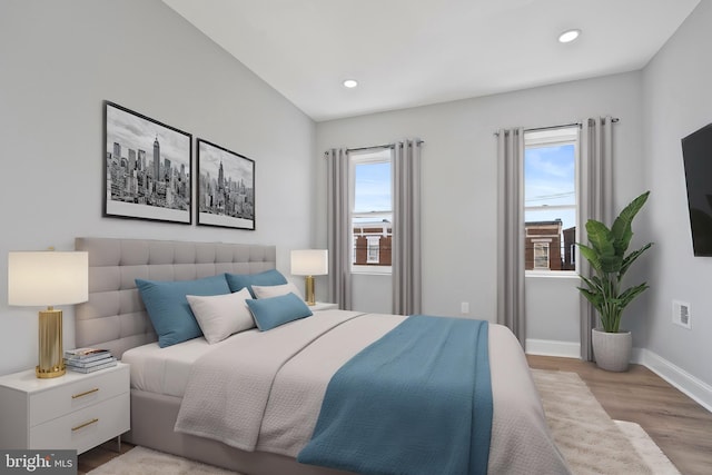 bedroom featuring light hardwood / wood-style flooring and multiple windows