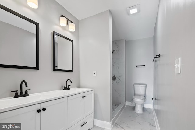 bathroom with toilet, vanity, and tiled shower