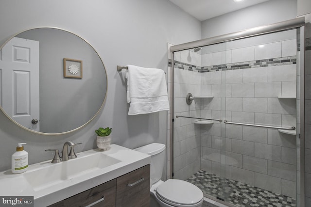 bathroom featuring vanity, toilet, and walk in shower