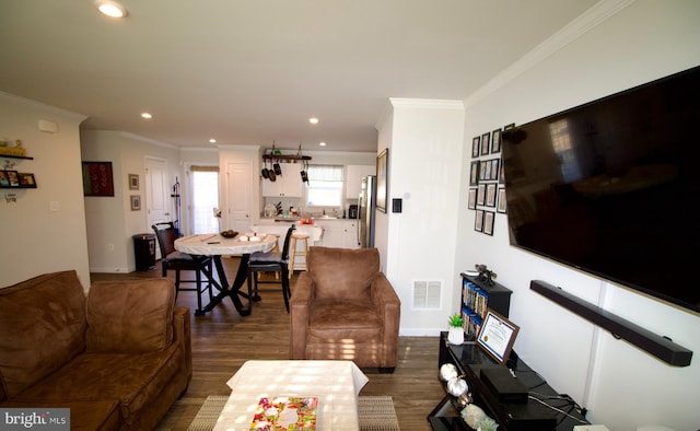 living room with dark hardwood / wood-style floors and crown molding