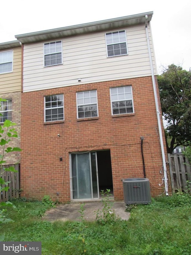 rear view of property featuring cooling unit