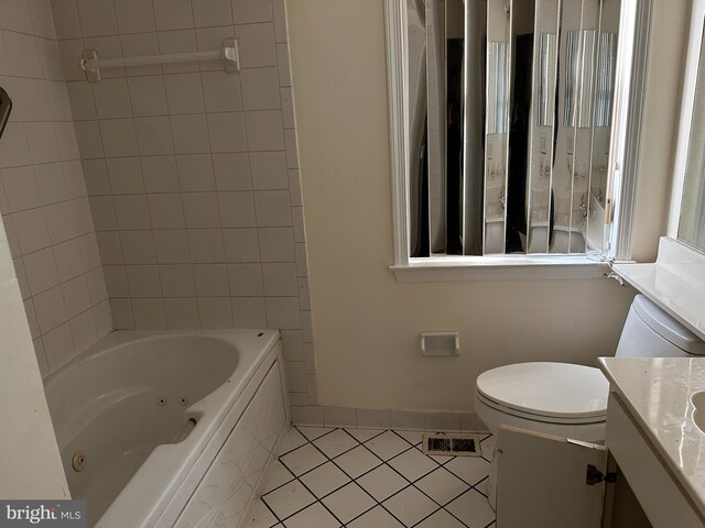 full bathroom with tile patterned floors, vanity, toilet, and tiled shower / bath combo