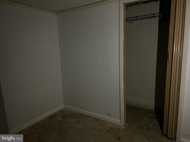 unfurnished bedroom featuring a closet and concrete floors