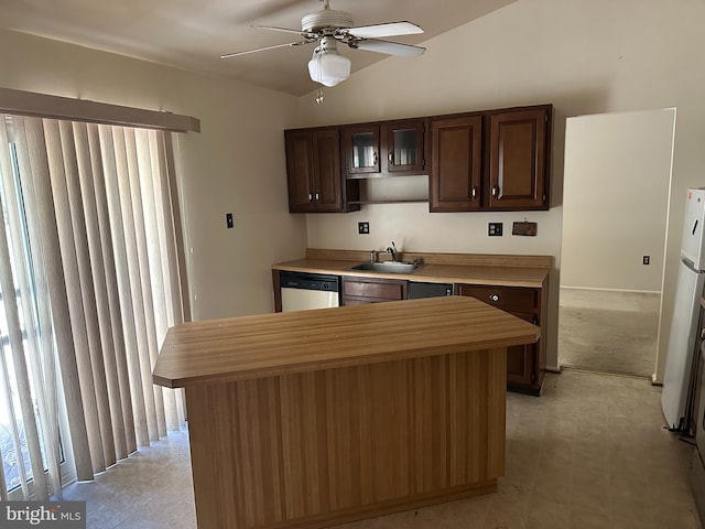 kitchen featuring dishwasher, sink, vaulted ceiling, ceiling fan, and dark brown cabinets