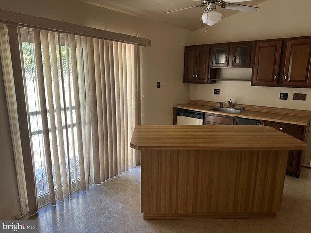 kitchen with dishwasher, a center island, sink, vaulted ceiling, and ceiling fan