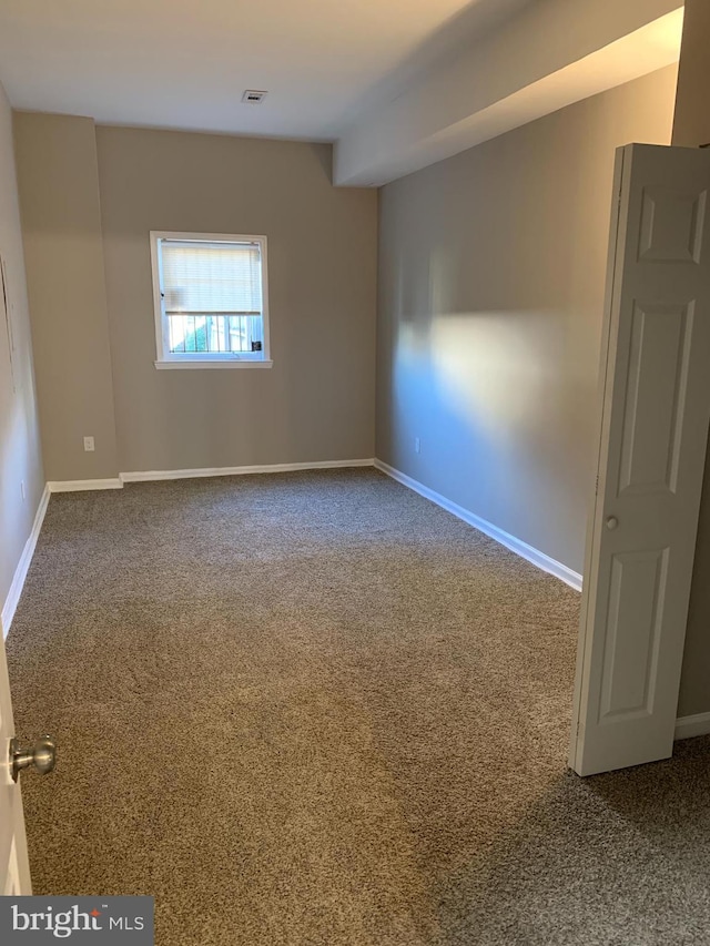 empty room with carpet flooring