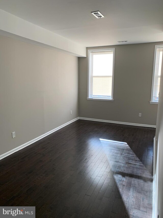 unfurnished room featuring dark hardwood / wood-style flooring