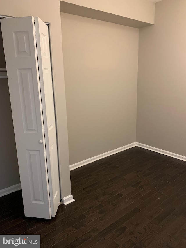 unfurnished room featuring dark hardwood / wood-style flooring