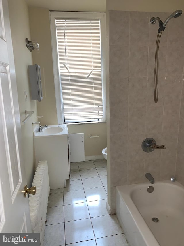 full bathroom featuring radiator, tiled shower / bath combo, tile patterned floors, toilet, and vanity