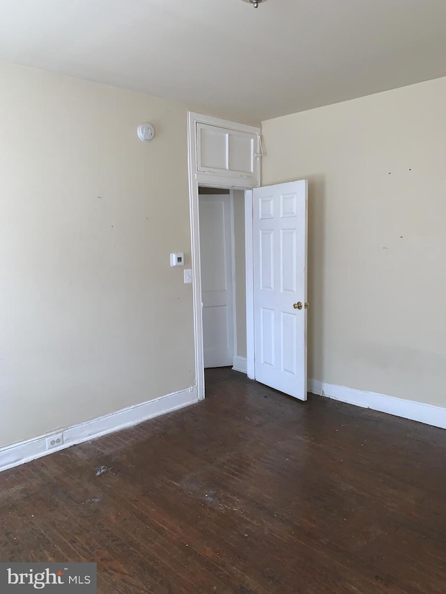 spare room with dark hardwood / wood-style floors