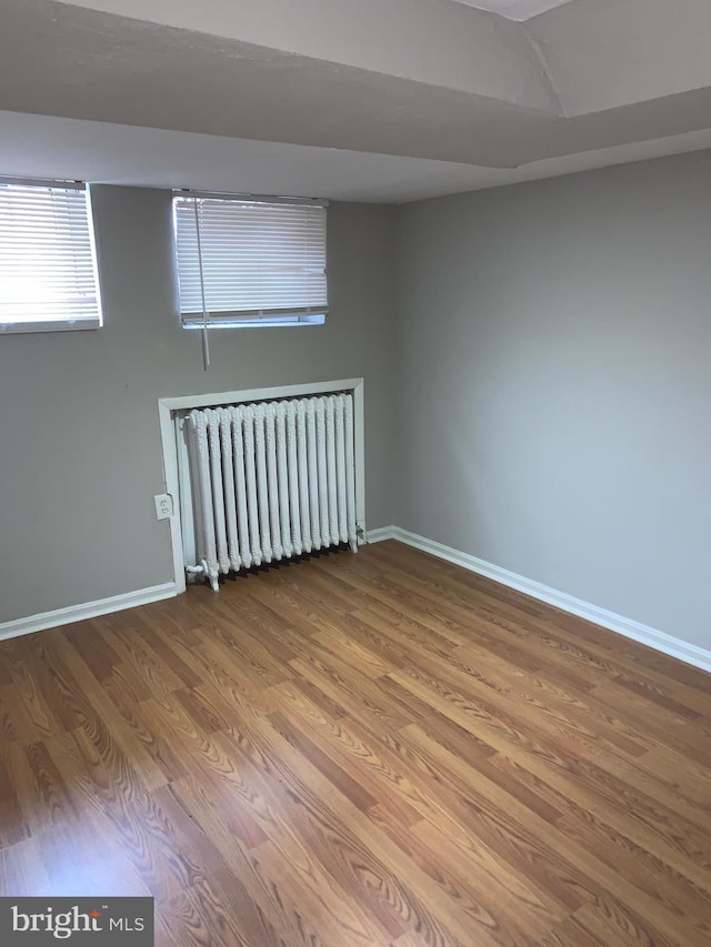 interior space with radiator and wood-type flooring