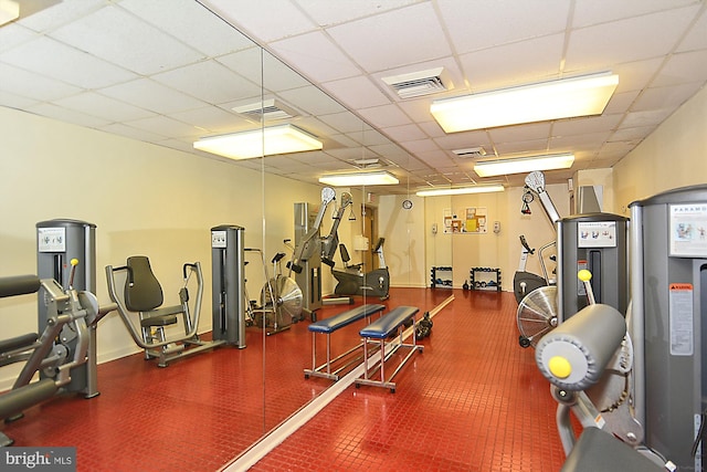 workout area featuring a paneled ceiling