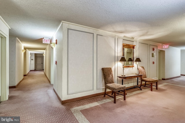 interior space with light carpet, a textured ceiling, and ornamental molding