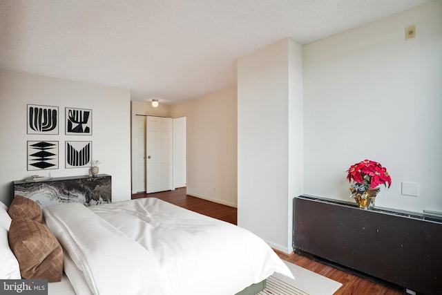 bedroom featuring dark hardwood / wood-style floors and a closet