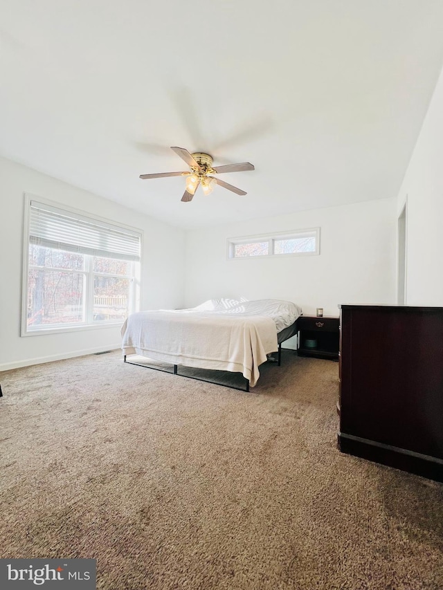 bedroom featuring ceiling fan and dark colored carpet