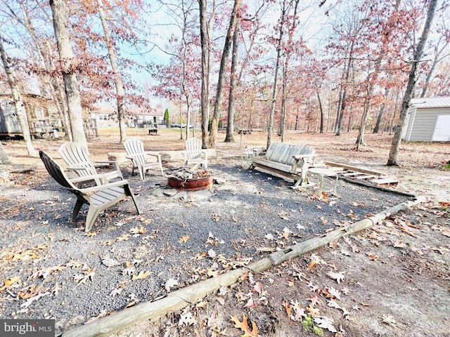 view of yard featuring an outdoor fire pit