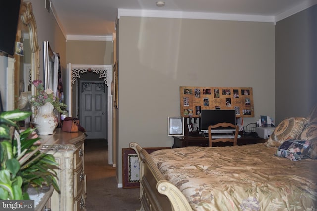 bedroom featuring crown molding and dark colored carpet