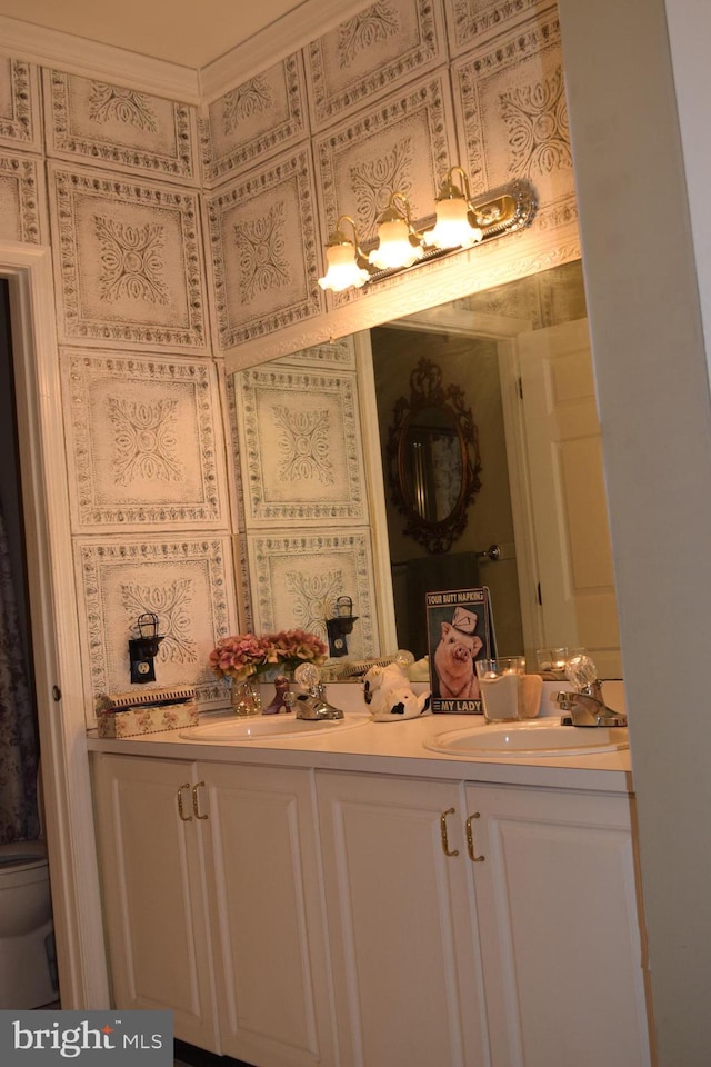 bathroom featuring vanity, toilet, and crown molding