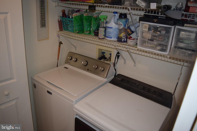 clothes washing area with washer and dryer