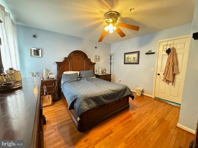 bedroom featuring light wood-type flooring, a closet, and ceiling fan