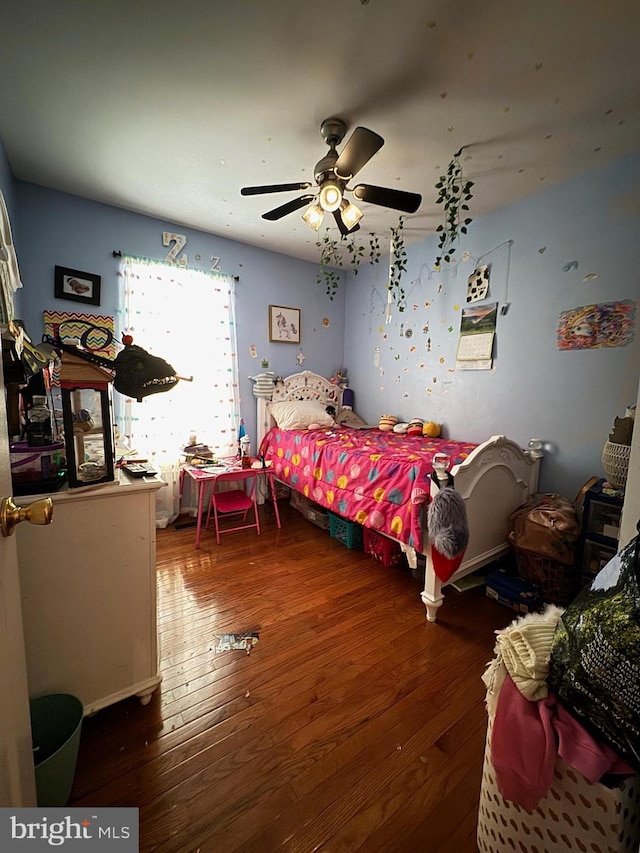 bedroom with ceiling fan and dark wood-type flooring