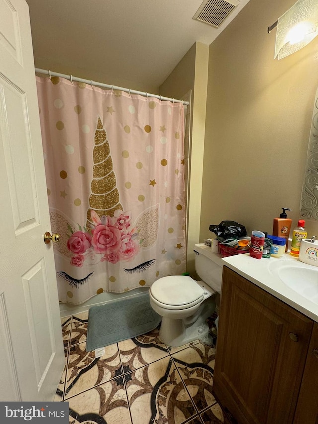 bathroom featuring tile patterned flooring, vanity, toilet, and a shower with shower curtain