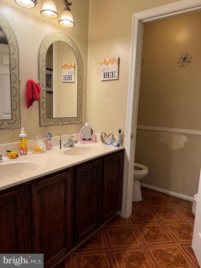 bathroom featuring vanity and toilet