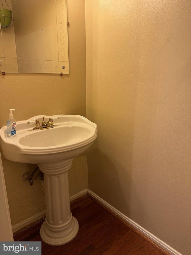 bathroom with wood-type flooring