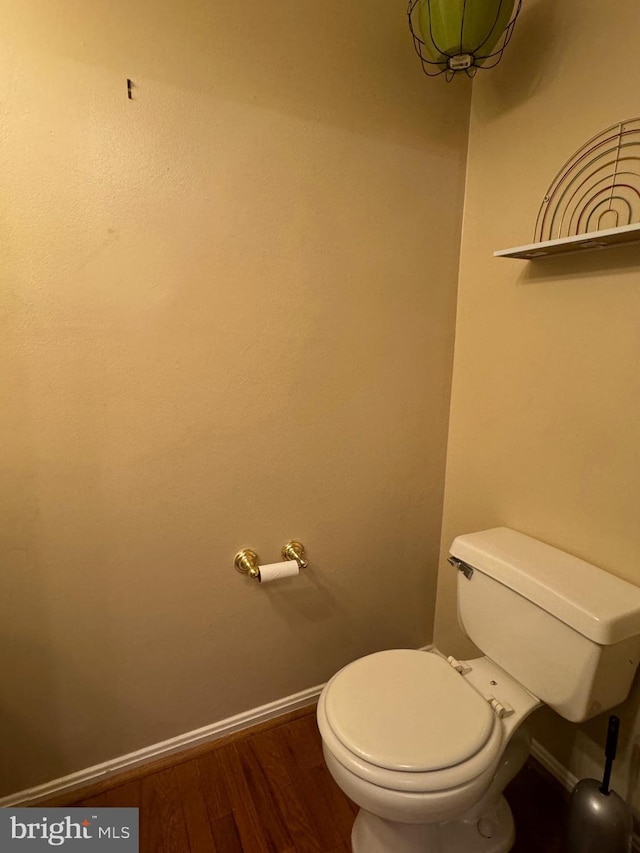 bathroom featuring hardwood / wood-style flooring and toilet