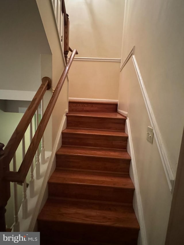 staircase with wood-type flooring