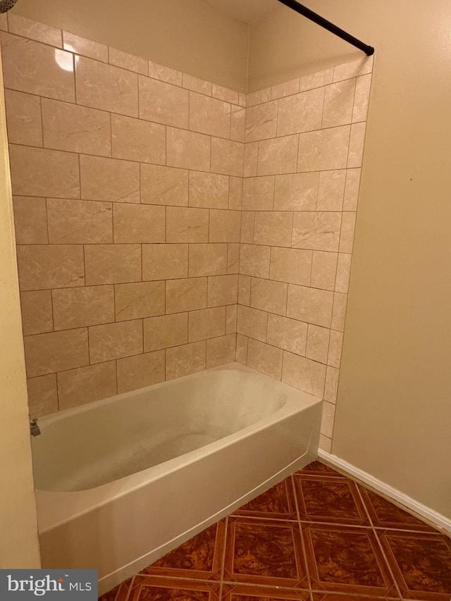 bathroom featuring tile patterned flooring and shower / tub combination