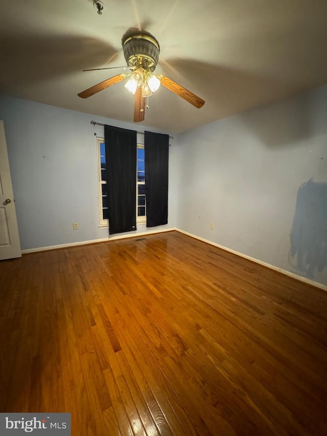 unfurnished room with hardwood / wood-style flooring and ceiling fan