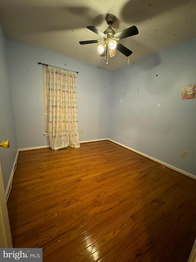 empty room featuring hardwood / wood-style floors and ceiling fan