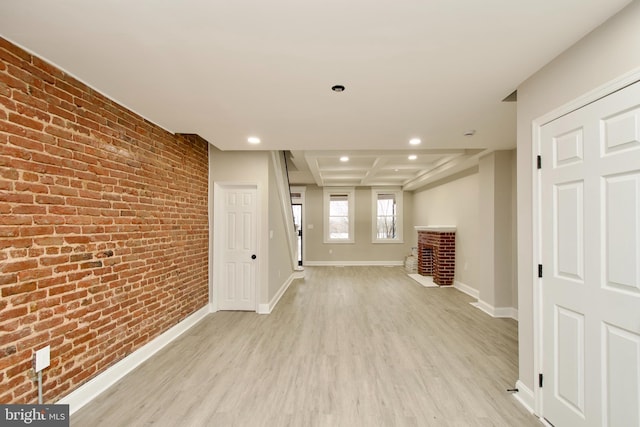 corridor with brick wall and light wood-type flooring