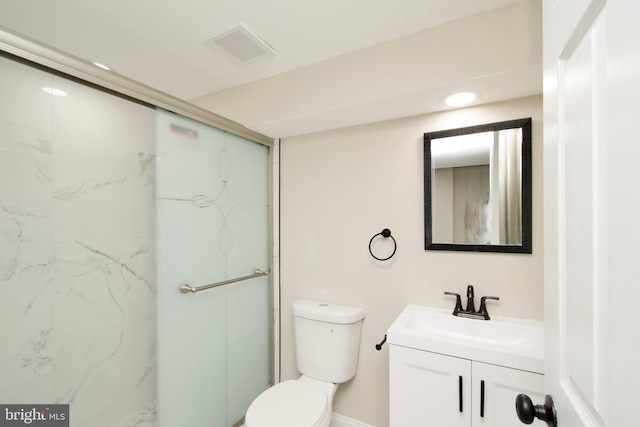 bathroom featuring vanity, toilet, and a shower with door