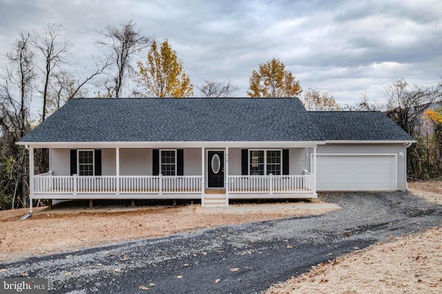 view of front facade with a porch and a garage