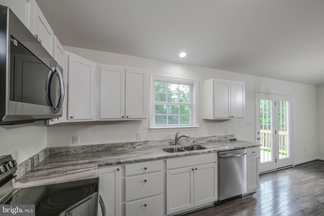 kitchen featuring white cabinetry, sink, stainless steel appliances, and plenty of natural light