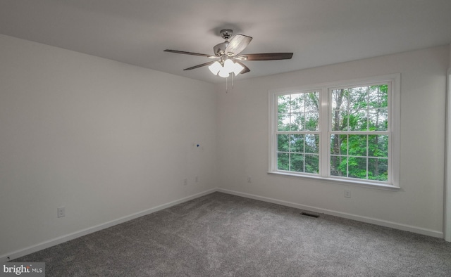 spare room featuring ceiling fan and carpet