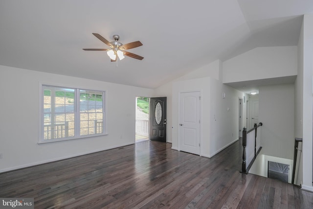 unfurnished living room featuring dark wood-type flooring, vaulted ceiling, and a healthy amount of sunlight