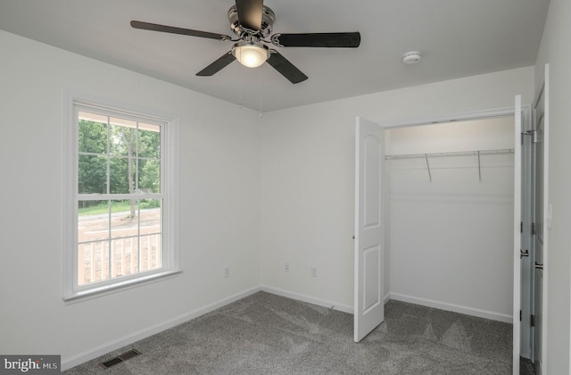 unfurnished bedroom with ceiling fan, a closet, and carpet