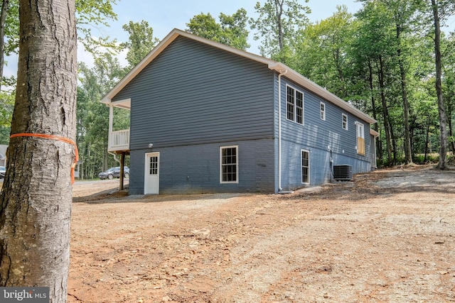 back of house with central air condition unit