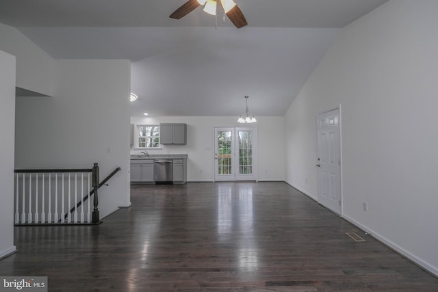 unfurnished living room featuring dark hardwood / wood-style flooring, high vaulted ceiling, and ceiling fan with notable chandelier