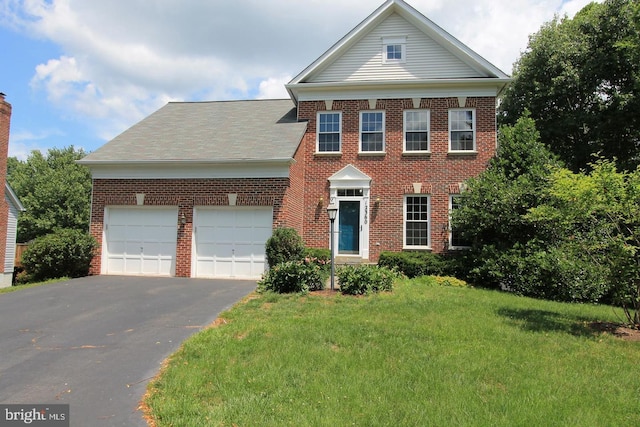 12360 Corncrib Ct, Bristow, VA 20136 - view of front of property with brick siding, asphalt driveway, an attached garage, and a front lawn