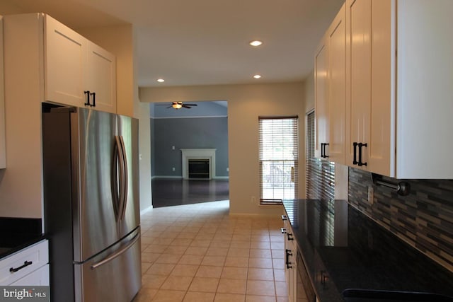 12360 Corncrib Ct, Bristow, VA 20136 - kitchen featuring freestanding refrigerator, backsplash, a ceiling fan, dark countertops, and a fireplace