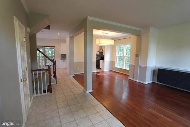 12360 Corncrib Ct, Bristow, VA 20136 - hall featuring light wood-type flooring, crown molding, baseboards, recessed lighting, and stairway