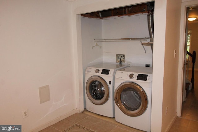 12360 Corncrib Ct, Bristow, VA 20136 - laundry room featuring washer and dryer, light tile patterned flooring, and baseboards