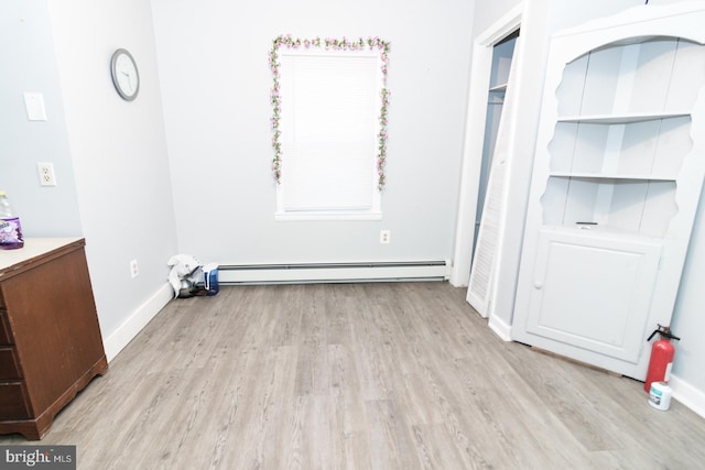 interior space featuring light hardwood / wood-style flooring and a baseboard heating unit