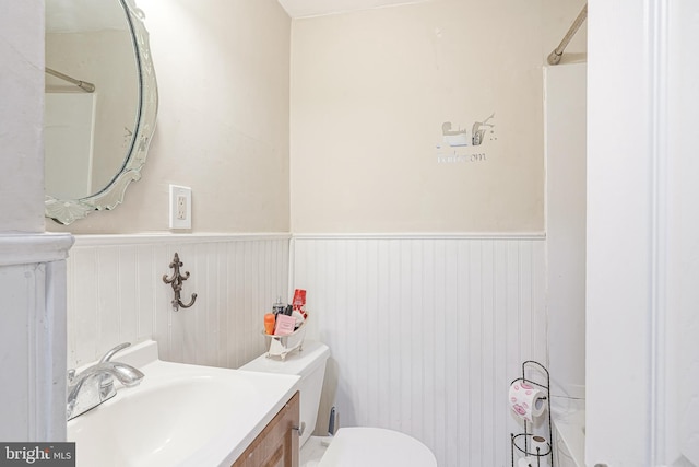 bathroom featuring vanity, toilet, and walk in shower